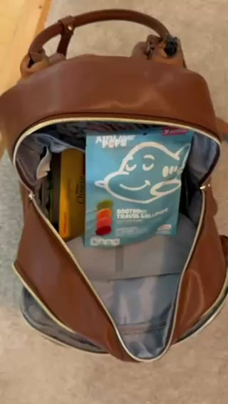 Girl carries a bag of AIRLINEPOPS Soothing Travel Lollipops through the airport and enjoys one on the plane