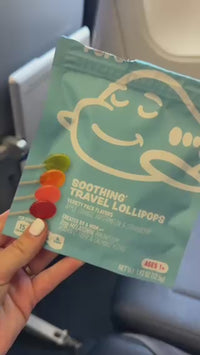 Family travel day with AIRLINEPOPS: lollipop at the window seat, boarding, and kids napping on the plane